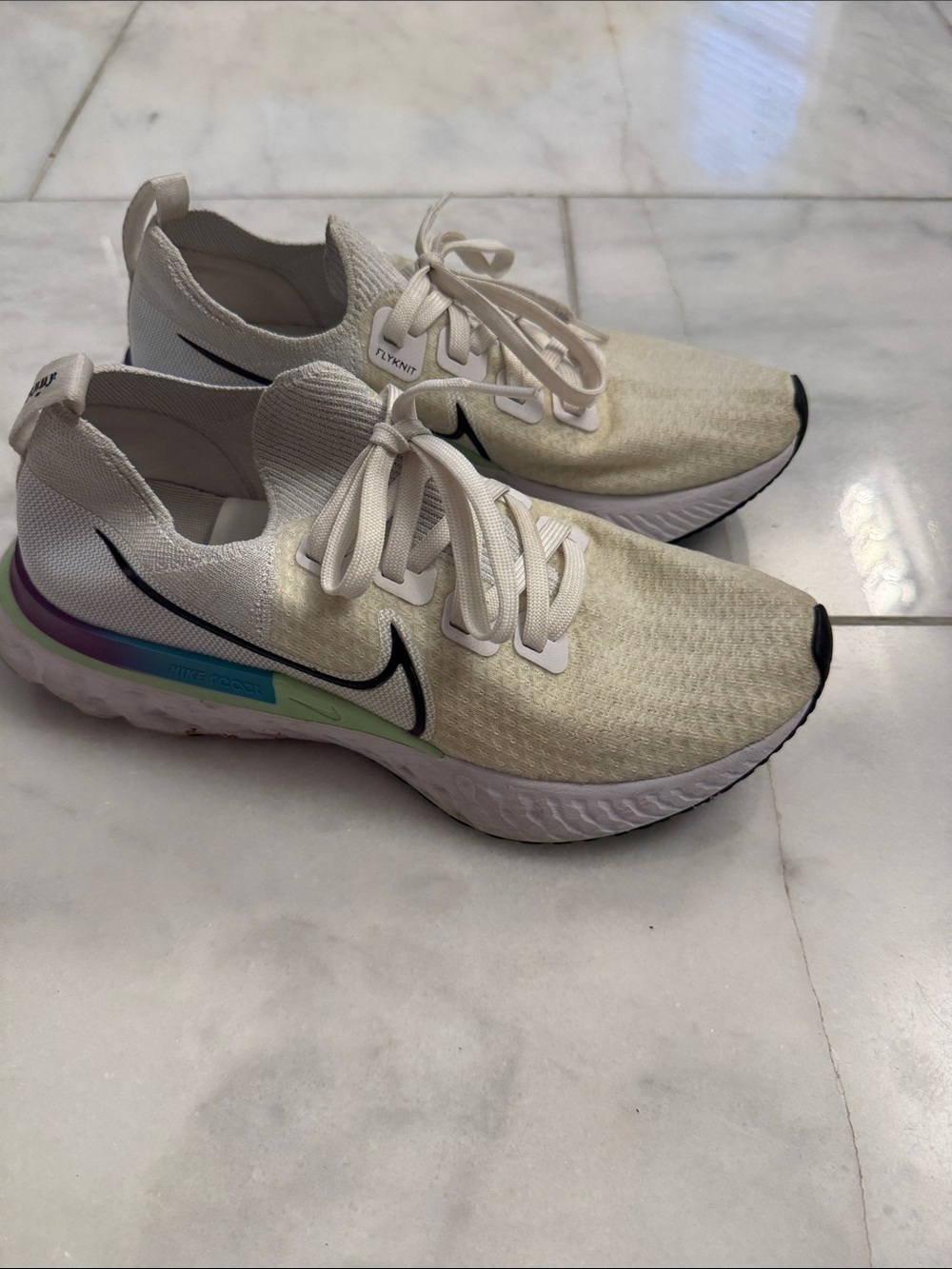 Nike Cream Flyknit Running Shoes with Black Swoosh and Pastel Accent